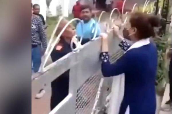 A woman waits outside the wedding venue as lover gets married