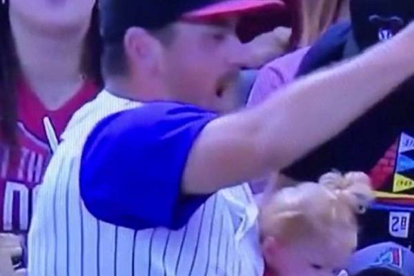 Father juggling the baby and beer while catching a baseball