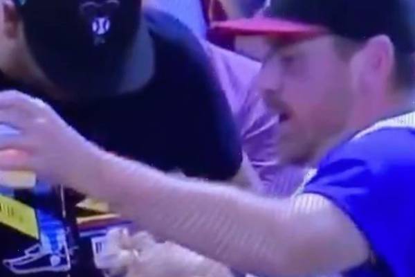 Father juggling the baby and beer while catching a baseball